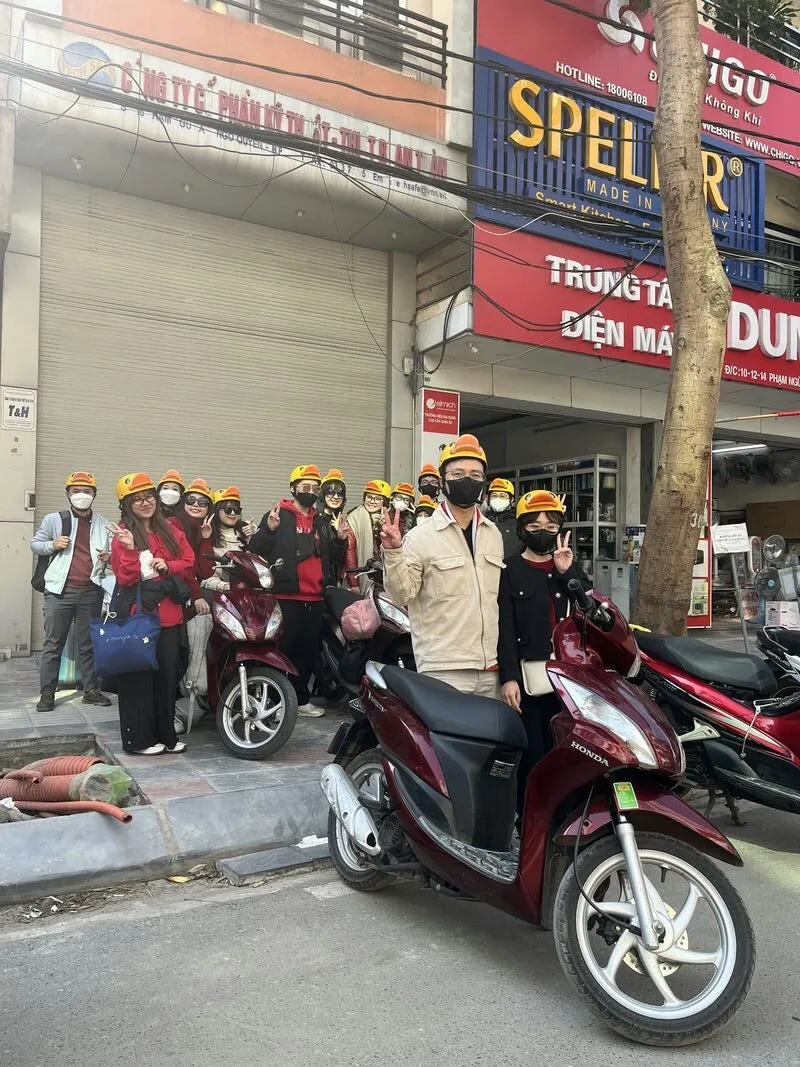 Customers happy to receive their bike at Haiphong Motorbike Rental with characteristic helmet