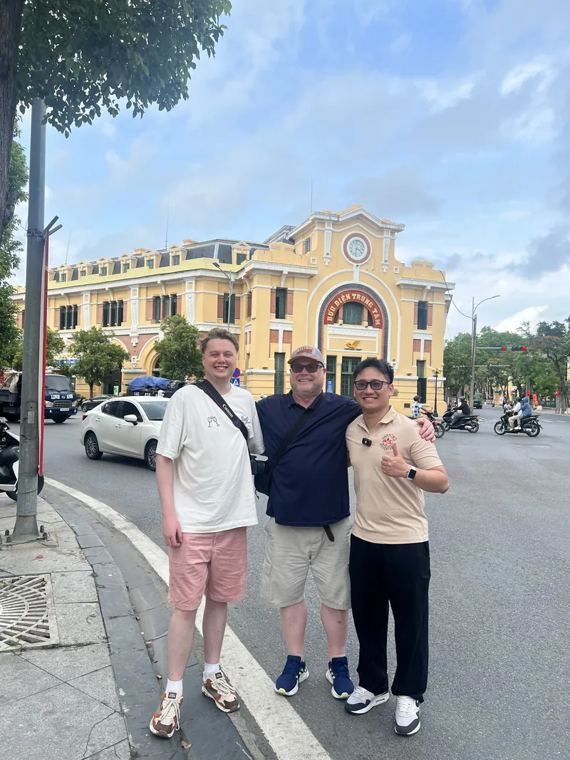 Guide and travelers on the street outside the French colonial Haiphong City Post Office